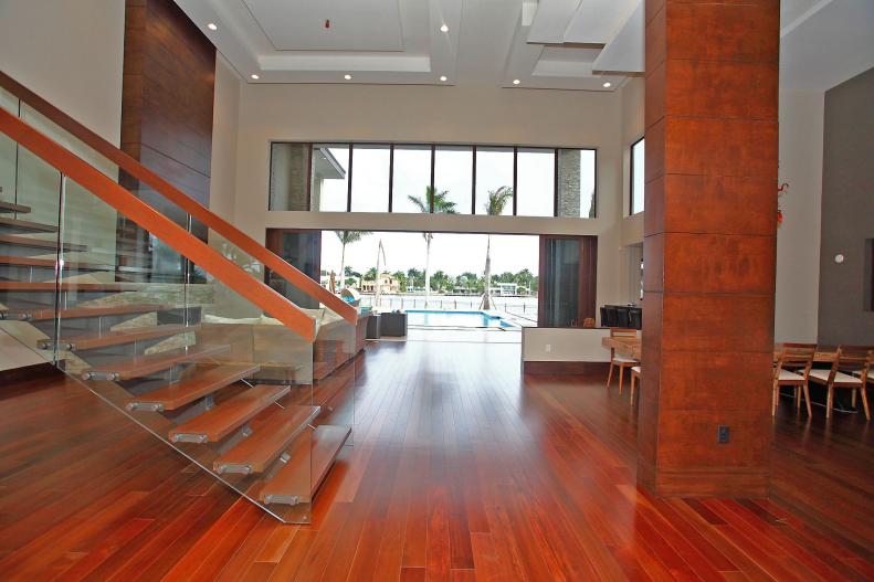 Contemporary Foyer With Wood Floor, Columns and Staircase