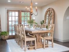 As seen on FIxer Upper, the Ignacio's remodeled dining room has new hardwood floors, french doors and a large dining room table. (After)