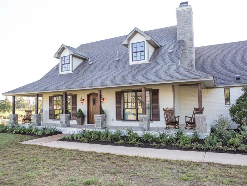 White Rustic Italian Exterior with Stone Chimney