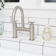 Kitchen With Silver Faucet and White Subway Tile