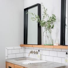 Primary Bath With Subway Tile and Black Mirrors
