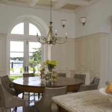 Breakfast Nook With Round Dining Table and Chandelier