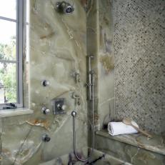 Standing Shower With Stone Tiling and Bench