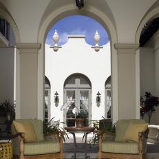 Arched Entrance to Outdoor Room With Armchairs