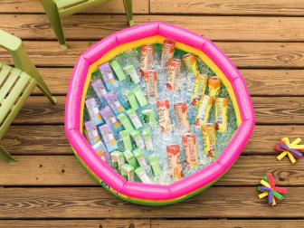 BABY POOL COOLER
Keep drinks ice cold and easy to access by filling up a baby pool with ice and the kids’ favorite bevvies.