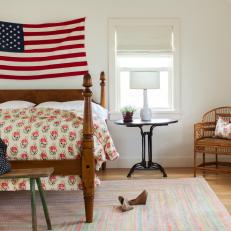 Contemporary Guest Room With Four-Post Bed and American Flag