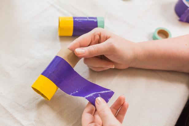 Add more tape in a different color to the middle of the roll (Image B). Finish off the rest in a third color, using the same method to finish the edge. Repeat on the other toilet paper roll so you have an identical pair. Then tape the two rolls together using coordinated color.