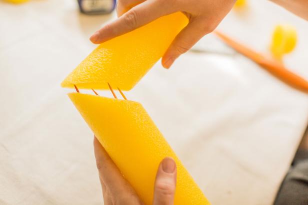 Insert several toothpicks into the angled ends of your cut pool noodle. Attach it to the angled ends of your two cut pieces until the toothpicks are totally embedded in the noodle, forming the end of your alley (Image A).