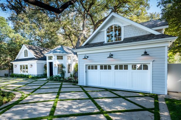 Courtyard and Driveway With Grass Growing Between Pavers in Daytime