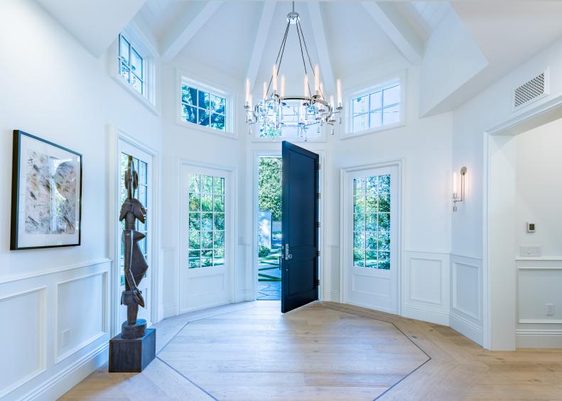 White Heptagonal Foyer With Round Chandelier and High Ceiling