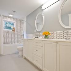 Kids' Gray-and-White Bath With Mosaic Tile and Round Mirrors