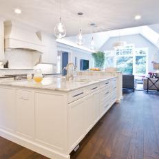White Kitchen With Large Central Island & Dark Wood Floor