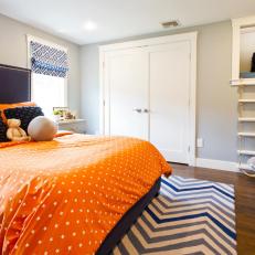 Kid's Bedroom With Orange Bed, Chevron Rug, and Giant Bear
