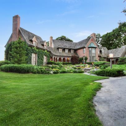 Tudor Manor With Lush Front Lawn and Landscaping