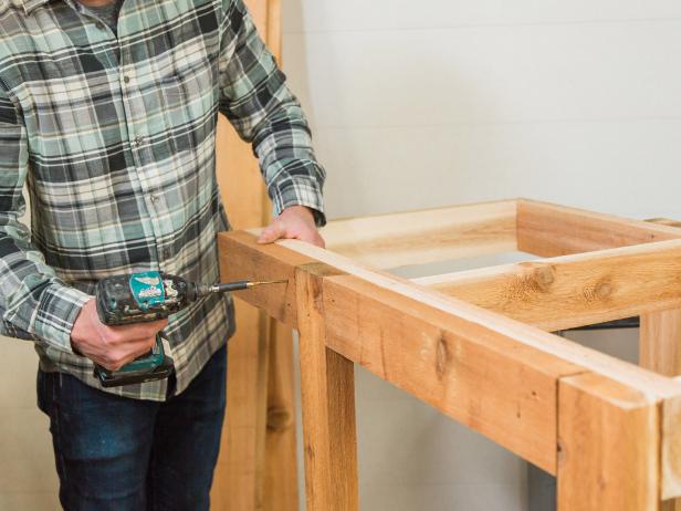 Flip the bar right side up, then measure and mark for the front bump out or apron boards. These will just give the front of the bar a nice smooth fascia. Ours measured 2”x4”x13” and 2”x4”x 19 ¾ “.  Secure to countertop frame using wood screws.