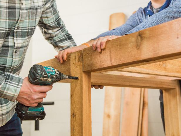 Add a 2”x4” nailer board so that you’ll have something to nail the vertical planks of the bottom cabinet to.  Ours measured 22 ½ inches. Secure using wood screws.