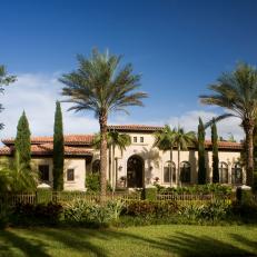 Mediterranean Home With Neutral Stucco Exterior and Spanish Tile Roof