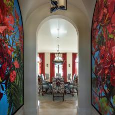 Bold Dining Room Entry With Custom Artwork and Arched Doorway