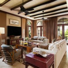 Tropical Family Room With Neutral Grasscloth Wallpaper and Exposed Beam Ceiling