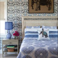 Eclectic Guest Room With Funky Print Wallpaper and Decorative Elephant Accents