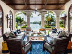 Blue and Neutral Covered Porch With Tropical Waterfront View