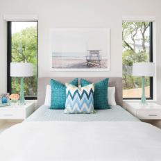 White Coastal Guest Bedroom With Turquoise Accents 