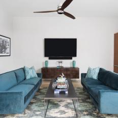 Contemporary Home Office With Teal Velvet Sofas and Metal Coffee Table