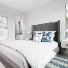 Transitional Bedroom With Gray Upholstered Bed and Blue Accents