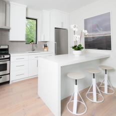 Guest House Kitchen With Gray Tile Backsplash and Natural Hardwood Floors 