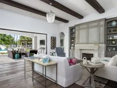 Gray and White Indoor-Outdoor Living Space With Exposed Beam Ceiling