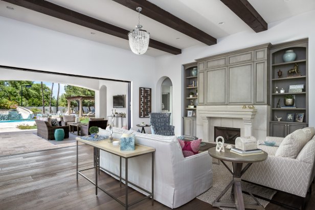 Gray and White Indoor-Outdoor Living Space With Exposed Beam Ceiling