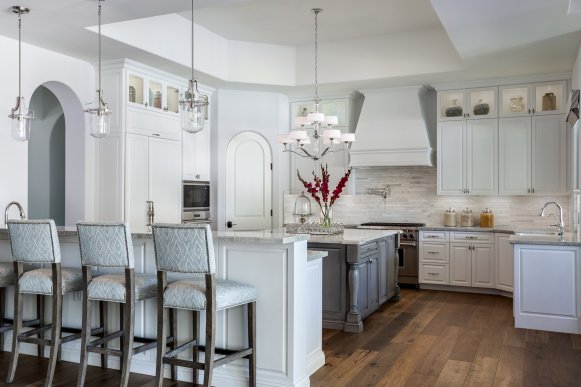 Kitchen With White Cabinets, Gray Kitchen Island and Hardwood Floors
