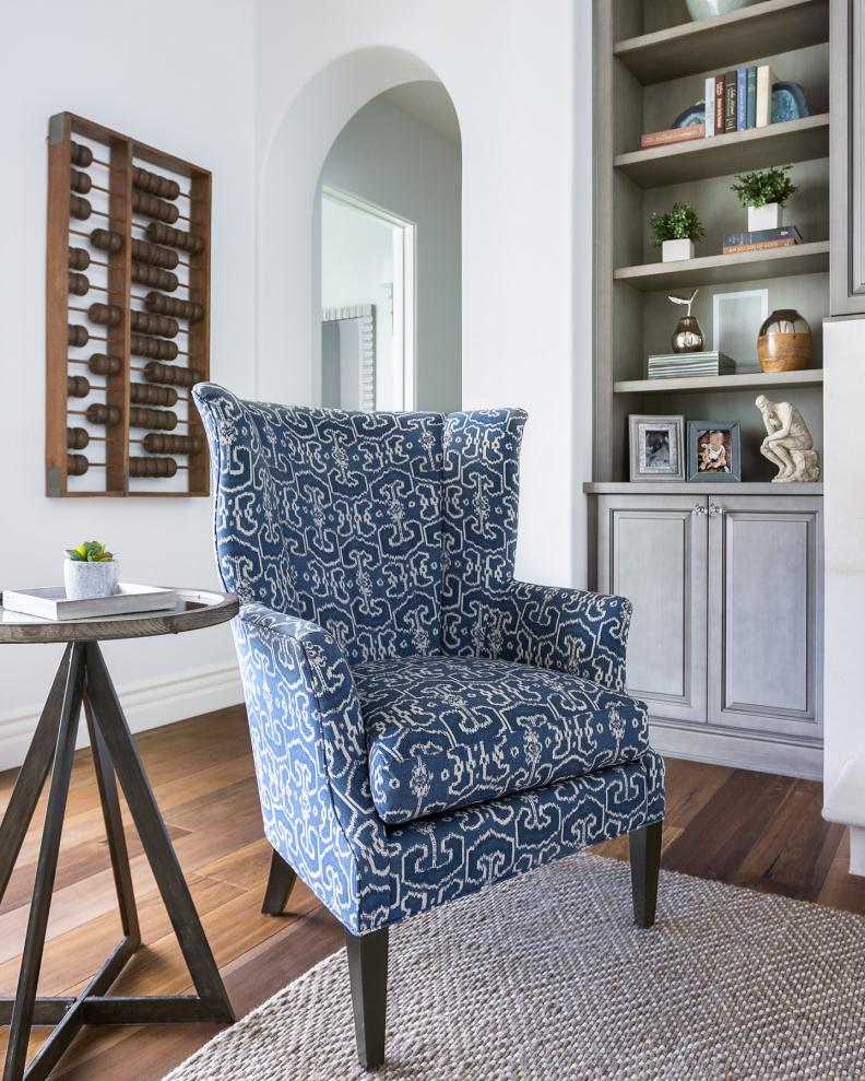 Family Room With Blue and White Armchair and Built-In Shelves