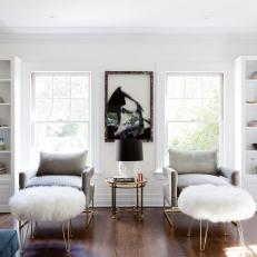 Contemporary Sitting Area With Gray Armchairs and Fur Ottomans
