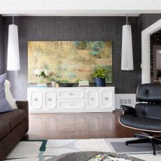 Contemporary Bonus Room With White Dresser and Leather Chair