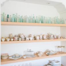 Open Shelves With Bottles and Teacups