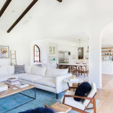 White Open Concept Living Room With Blue Rug