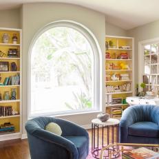 Eclectic Living Room With Yellow Bookshelves