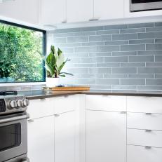 Blue-Gray Glass Tile Backsplash Adds Color to Sleek, Modern Kitchen