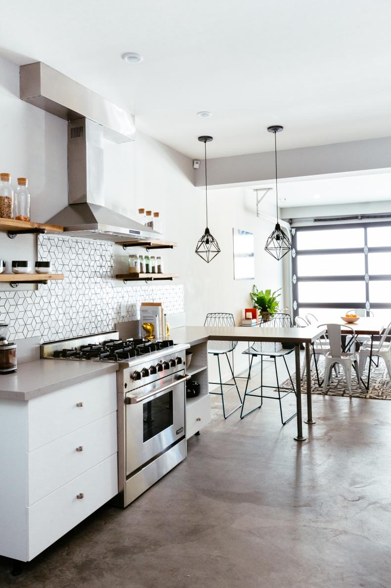 Communal Kitchen and Dining Area with Concrete Floor and Garage Door