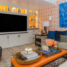 Custom Media Cabinetry With White Exteriors and Orange Interiors