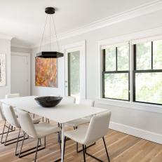 White Contemporary Dining Room With Wood Floor