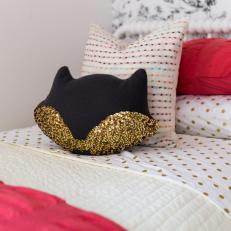 Girls' Bed Styled With Gold Sheets, Sequined Pillows