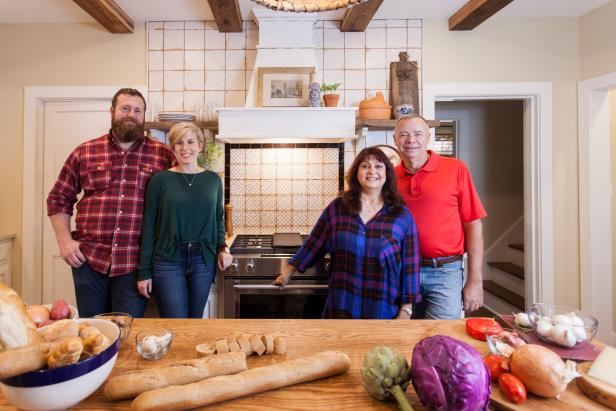 As seen on Home Town, homeowners Scott and Linda Carson (R) stand with hosts Ben and Erin Napier (L) in the newly renovated kitchen. After the renovations, their Laurel, MS kitchen now features a completely renovated French Country styled kitchen with new distressed cabinet doors, new appliances, new floor and wall tile, new heart pine reclaimed beams and a custom built Scotsman white oak table built by host Ben Napier. (portrait)