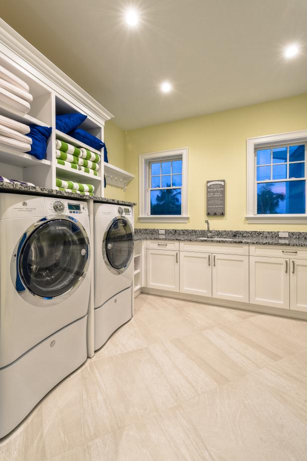 Yellow Laundry Room With Striped Towels | HGTV