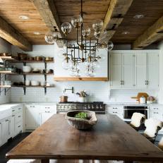 Farmhouse Dining Table with Wrought Iron Chairs in Rustic, Industrial Kitchen