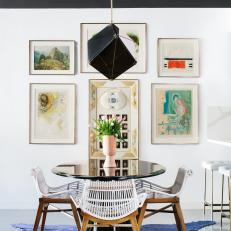Eating Area With Round Black Table and Modern Pendant Light