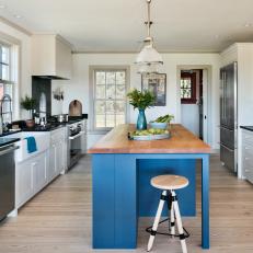 White Farmhouse Kitchen with Bold Blue Island