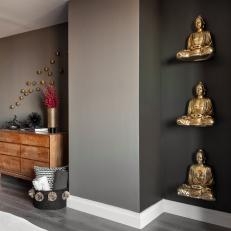 Two-Tone Gray Den With Gold Statues and Simple Wood Dresser
