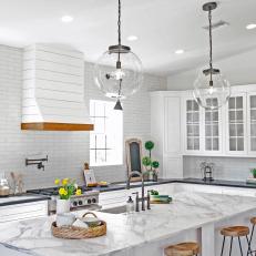 White Kitchen With Shiplap Hood and Marble Counter Island